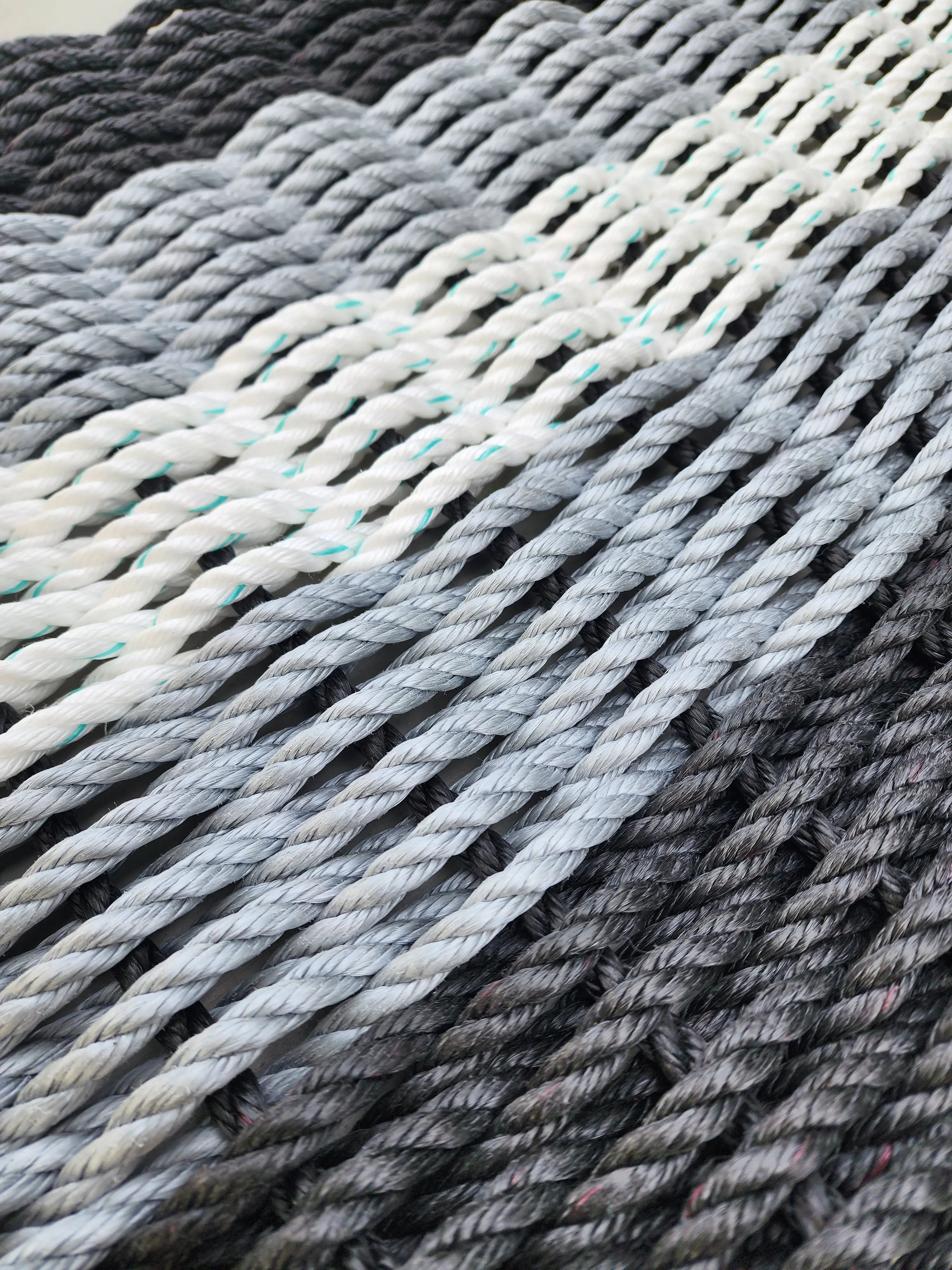 Black, gray and white rope doormat