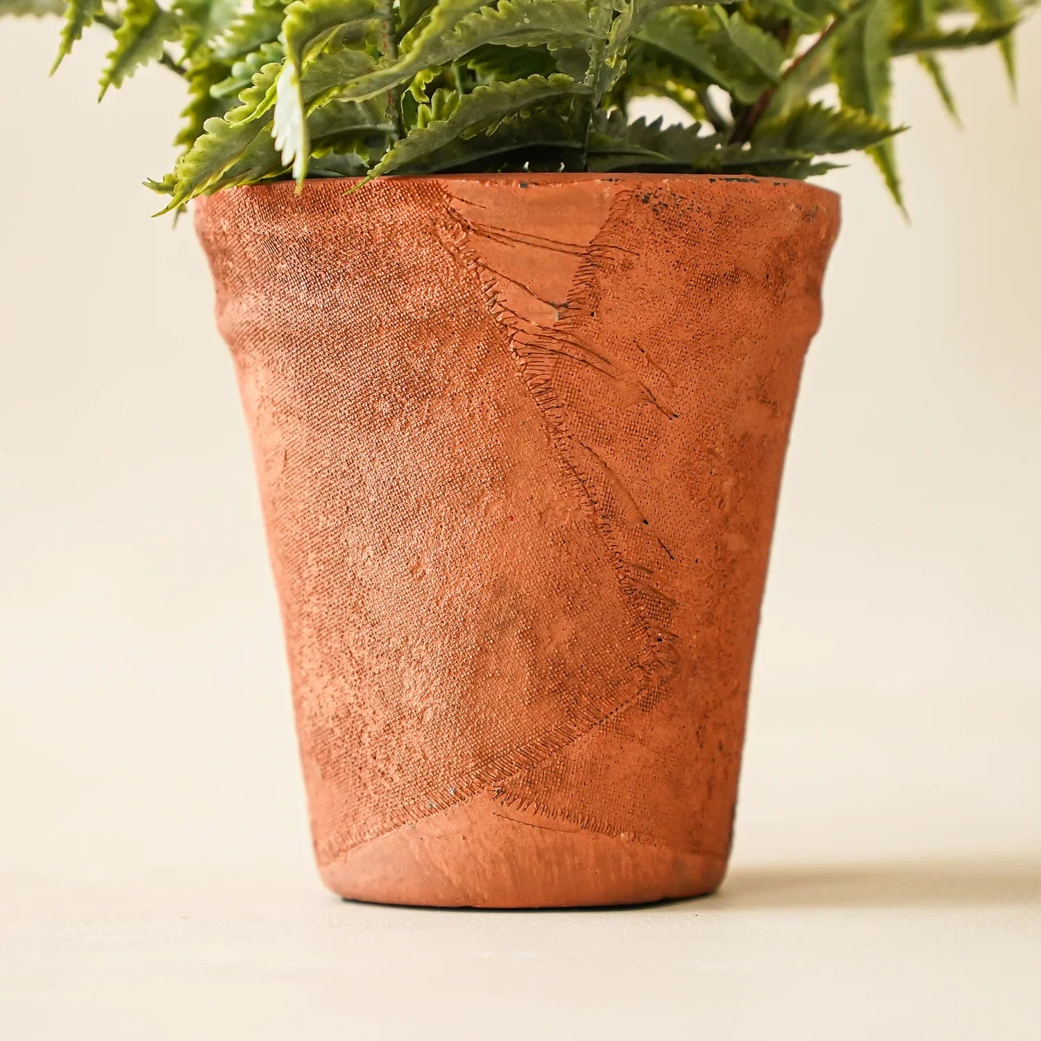 Faux fern in terracotta pot