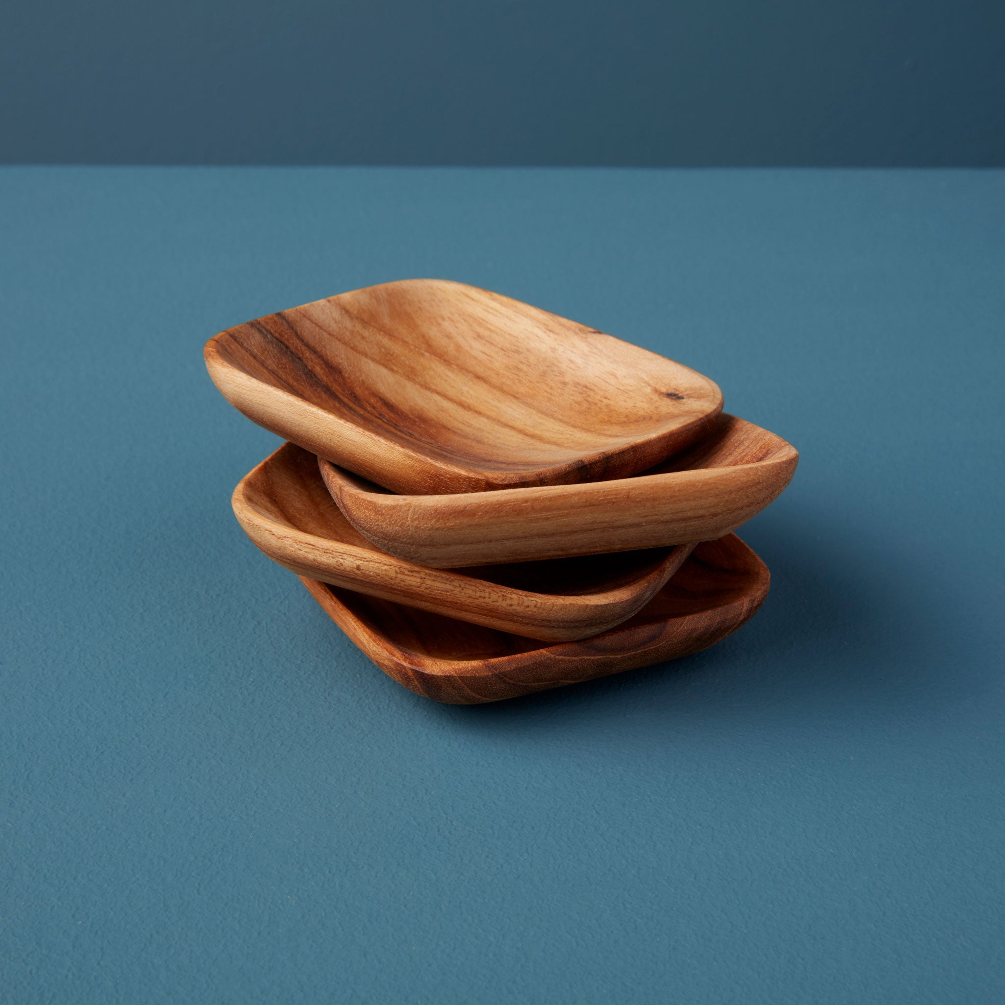 Set of four compact teak square serving bowls