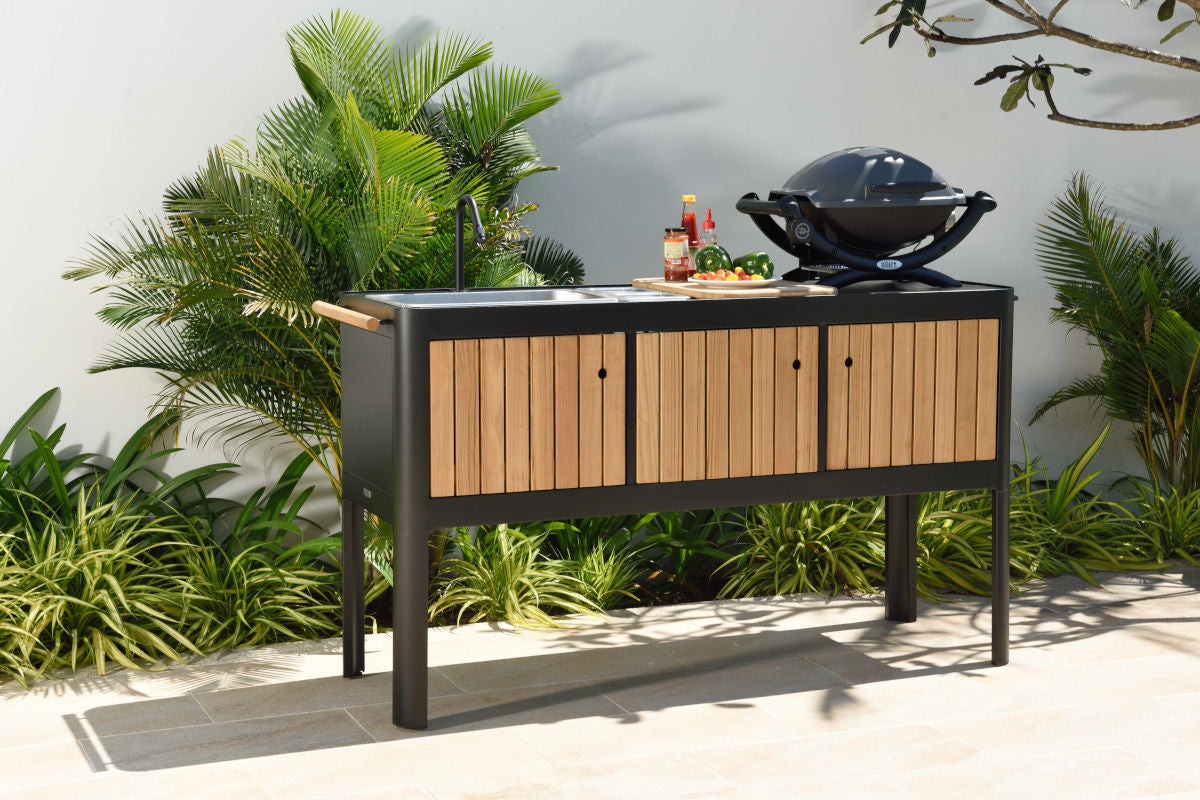 Portals dark outdoor kitchen with sink and cutting board